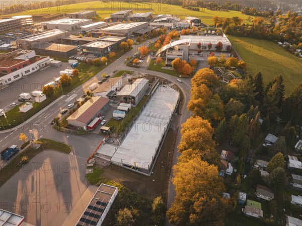 Aerial view of a commercial area in autumn with colorful trees, Calw, Black Forest, Germany