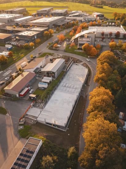 Aerial view of a commercial area in autumn with colorful trees, Calw, Black Forest, Germany