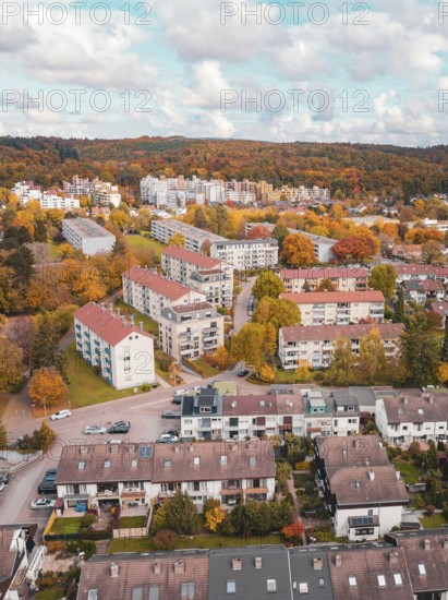 Colourful residential development in autumnal nature with bright clouds, Sindelfingen, Böblingen district, Germany