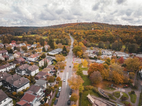 Aerial view showing road leading through autumnal hills and colorful forests, Sindelfingen, Böblingen district, Germany