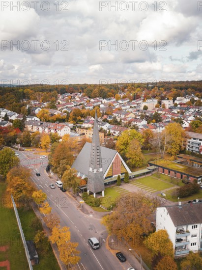 Aerial view of a village with a distinctive church and colorful autumn trees, Sindelfingen, Böblingen district, Germany