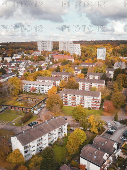 Overview of a city with colorful autumn trees and cloudy sky, Sindelfingen, Böblingen district, Germany