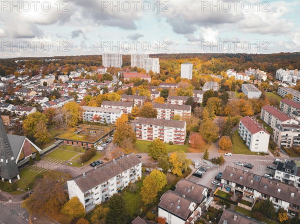 Residential area with colorful houses and trees in an autumn mood under cloudy sky, Sindelfingen, Böblingen district, Germany