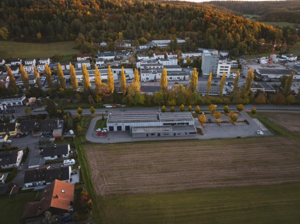 Fire station and trees in autumn landscape at dusk, Aidlingen, Böblingen district, Germany