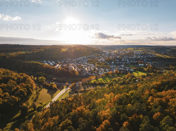 Colourful autumn landscape with a view of a village and vast forests under the evening sun, Aidlingen, Böblingen district, Germany