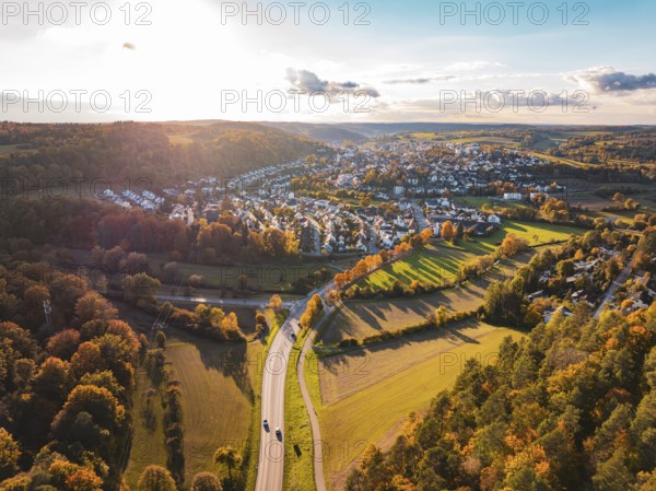 Wide landscape with a village surrounded by glowing autumn trees and fields, Aidlingen, Böblingen district, Germany