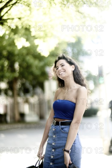 Carefree smile feeling a bit stiff with her arms, the laughing loosens up her body tension