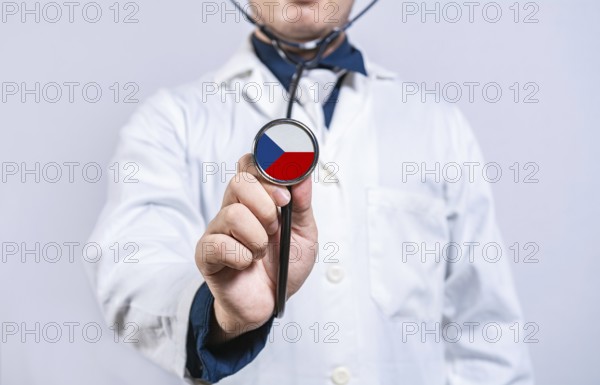 Doctor holding stethoscope with czech flag. Czech health and care concept