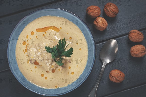 Satsivi, Georgian dish, chicken in nut sauce, cold appetizer, on a wooden table, no people, homemade