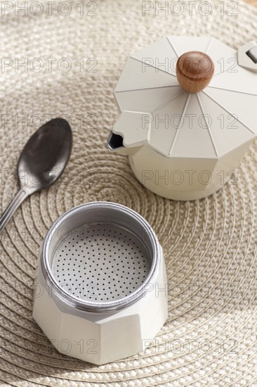 Geyser coffee maker, empty and clean, disassembled on the table, coffee preparation, sunlight, breakfast