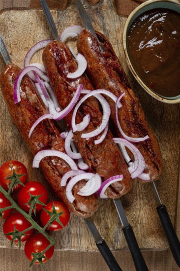 Fried sausages, in English with bacon, for grilling, on a cutting board, top view, no people