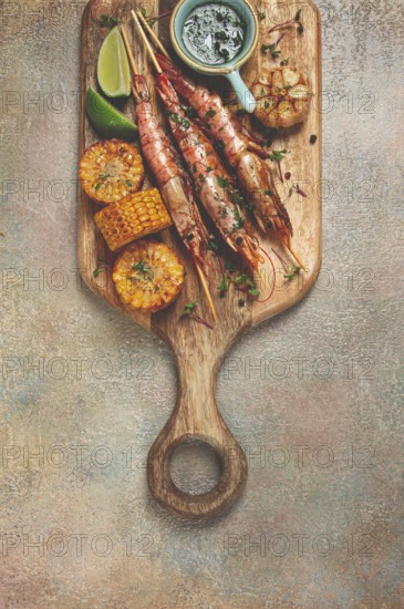 Langoustines on skewers, shrimp kebab, with fried corn, spices and herbs, homemade, no people