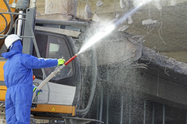 Demolition work in building construction. water jet against dust and dirt. Paderborn, North Rhine-Westphalia, Germany