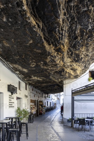 On the road to the white villages. Paths and narrow streets of a historic old town with many white houses were built around and in the mountain. Setenil de las Bodegas, Cadiz, Andalusia, Spain