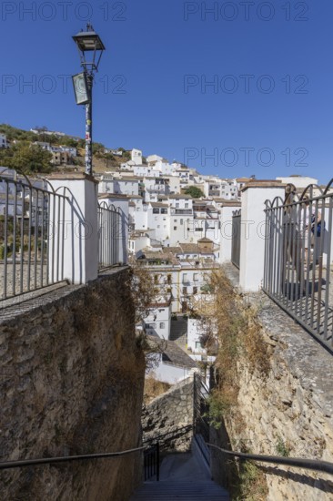 On the road to the white villages. Panorama or skyline of a historic old town with many white houses built on and in the mountain. Setenil de las Bodegas, Andalusia, Spain