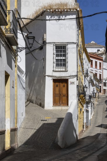 On the road to the white villages. Paths and narrow streets of a historic old town with many white houses built on and in the mountain. Setenil de las Bodegas, Cadiz, Andalusia, Spain