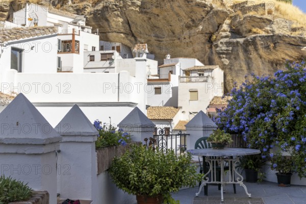On the road to the white villages. Paths and narrow streets of a historic old town with many white houses built on and in the mountain. Setenil de las Bodegas, Cadiz, Andalusia, Spain