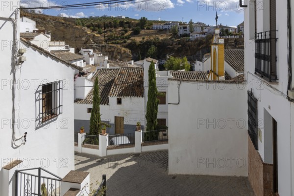 On the road to the white villages. Paths and narrow streets of a historic old town. Ermita de San Benito Church in Setenil de las Bodegas, Cadiz, Andalusia, Spain
