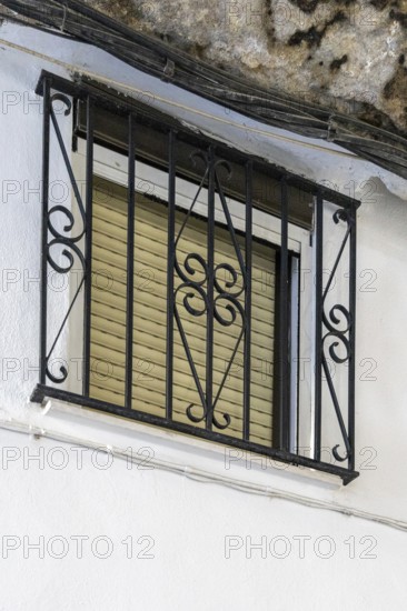 On the road to the white villages. Beautiful windows of the historic old town in Setenil de las Bodegas, Cadiz, Andalucia, Spain