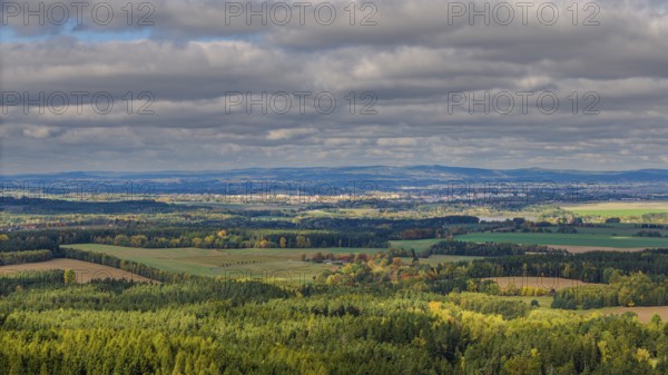A wonderful view of an extensive green landscape in the Czech Republic during autumn. The clouds in the sky make the colors of nature shine. Cheb, Czech Republic