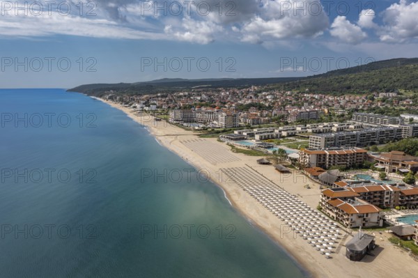 Aerial view of a long sandy beach stretching along a coastal city. Aerial view to a sea resort Obzor on Black sea in Bulgaria