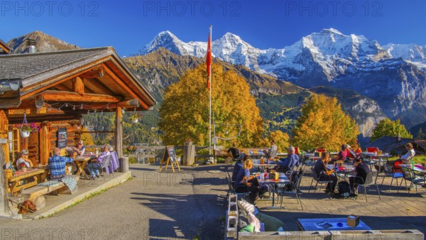 Sun terrace of the mountain inn in the hamlet of Sulwald with Eiger 3967m, Mönch 4110m and Jungfrau 4158m in autumn, Isenfluh, Lauterbrunnental, Bernese Oberland, Canton of Bern, Switzerland