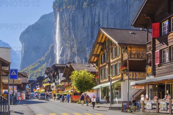 Village road with Staubbach waterfall, Lauterbrunnen, Bernese Oberland, Canton of Bern, Switzerland