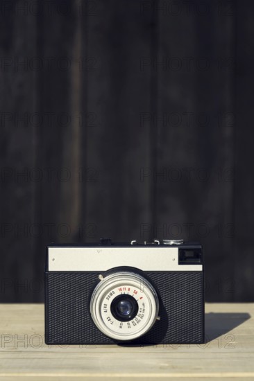 Old vintage filtered camera on wooden background Prague Czech republic