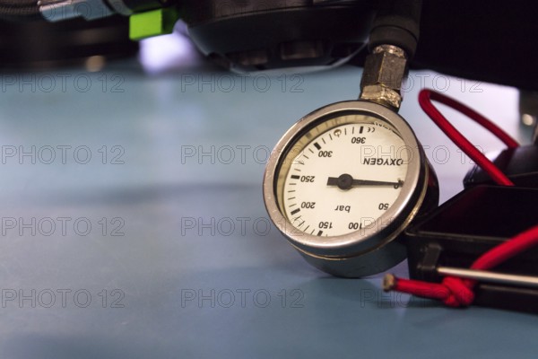 Gas pressure indicator, scuba diving oxygen lying on blue table background, copy space Prague Czech republic
