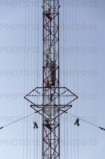 Men painting the highest Czech construction radio transmitter tower Liblice Czech republic