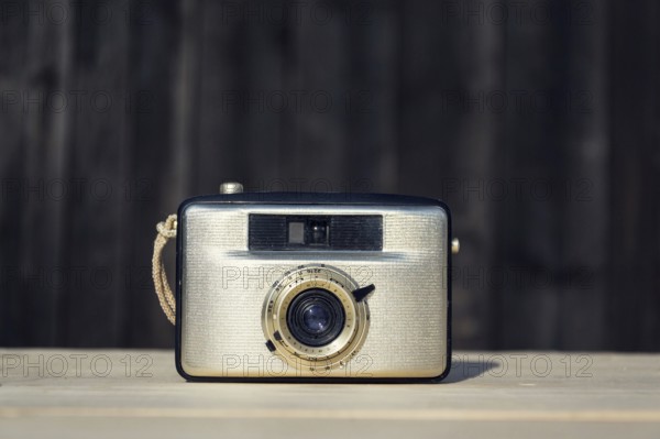 Old vintage golden Penti I camera on wooden background Prague Czech republic