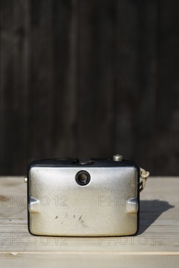 Back of old vintage golden Penti I camera, wooden background Prague Czech republic