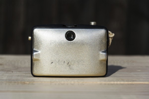 Back of old vintage golden Penti I camera, wooden background Prague Czech republic