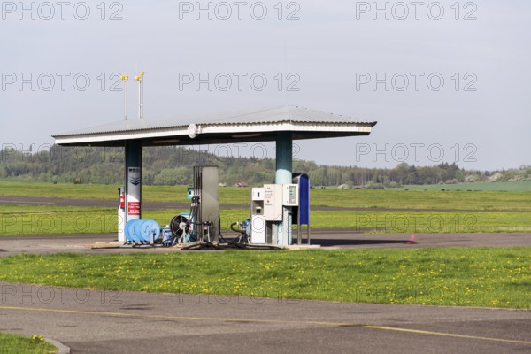Aviation fuel filling station on airport with airfield runway in background on a sunny spring day Prague Czech republic