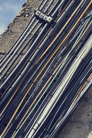 Filtered vintage bunch of data cables outside mounted on wall Prague, Czech republic