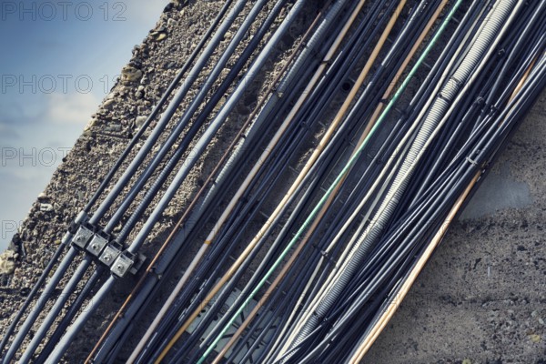 Filtered vintage bunch of data cables outside mounted on wall Prague, Czech republic