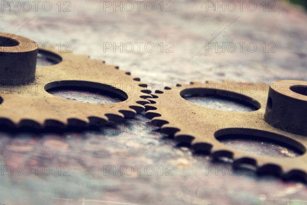 Filtered picture of cogwheels on a colorful wooden background Prague, Czech republic