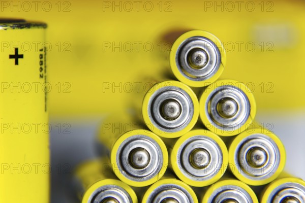 Stack of yellow AA batteries close up abstract coloured background Prague, Czech republic