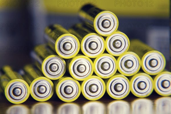 Stack of yellow AA batteries close up abstract color background Prague, Czech republic