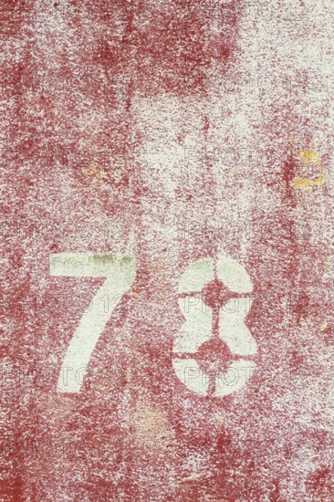 Number 78 on vintage rusty red and white metal sheet plate Prague, Czech republic