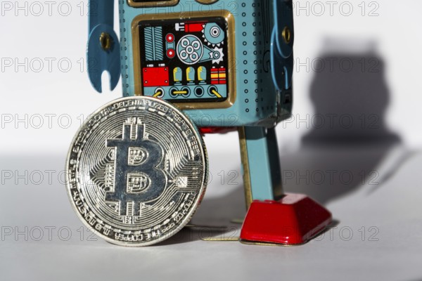 Vintage tin toy robot with bitcoin coin, cryptocurrency mining concept Prague Czech republic