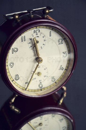 Filtered picture of a vintage alarm clock on a mirror backgroud Prague Czech republic