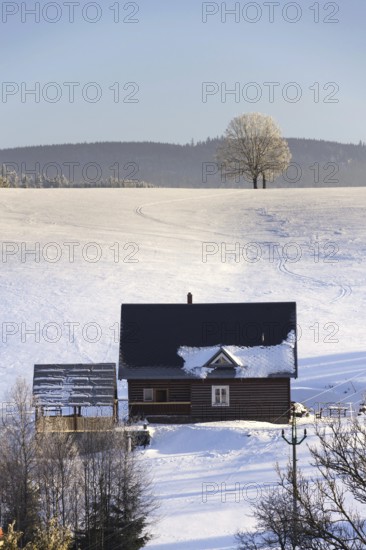 Timbered cottage in frosty mountains country in sunny winter day Neratovice Czech republic