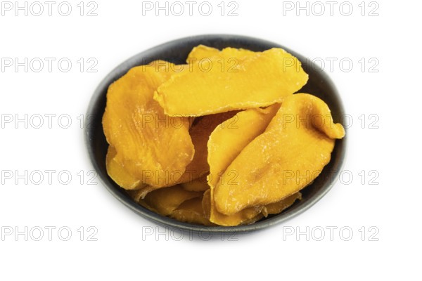 Dried Mango in blue ceramic bowl isolated on white background. Side view, close up, flat lay. healthy food, minimalism