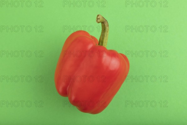 Red pepper on green pastel background. Top view, flat lay, copy space. healthy food, vegetable, minimalism