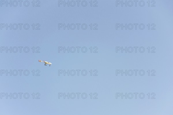 Unmanned aerial vehicle surveillance drone with light and camera flying, sunny summer day, drone delivery concept, copy space on clear sky Pisek Czech republic