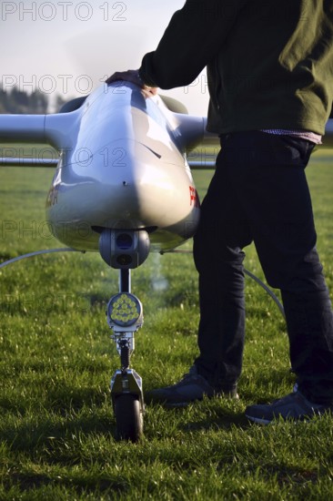 Man preparing unmanned aerial vehicle drone with light and camera Pisek Czech republic