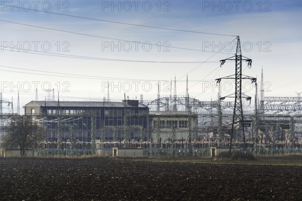 Distribution power station with electricity pylons and dramatic cloudy sky background Prague Czech republic
