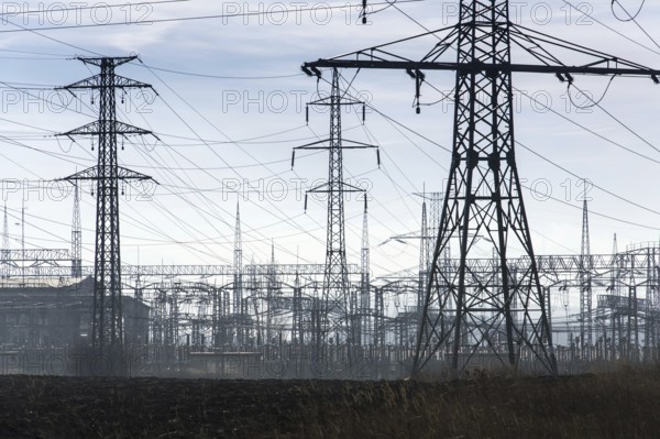 Electricity pylons with distribution power station blue cloudy sky Prague Czech republic