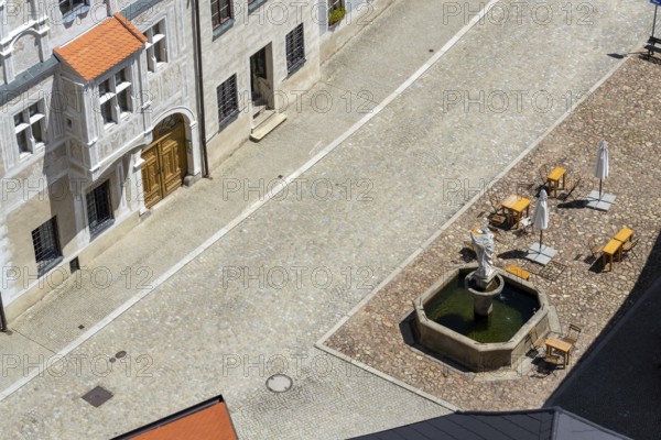 Aerial view of the café tables around the fountain on the square, sunny summer day Slavonice Czech republic